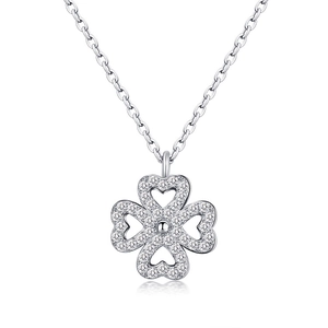 Macro view of silver four-leaf clover necklace with heart petals and white zircon stones