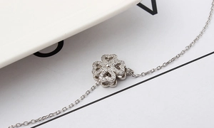 Close-up of double-layered heart-shaped clover necklace with micro-pave crystals