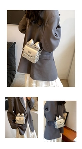 Detail of silver metallic mini bag with bow accent and crossbody chain strap