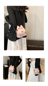Pink mini chain box bag with large bow detail and silver metal hardware strap