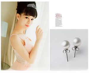 Detailed set of elegant round white pearl earrings and matching bridal jewelry ensemble