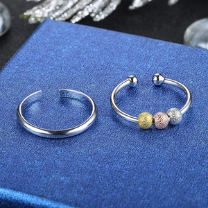 Close-up of adjustable fidget ring set with three-color metallic moving beads