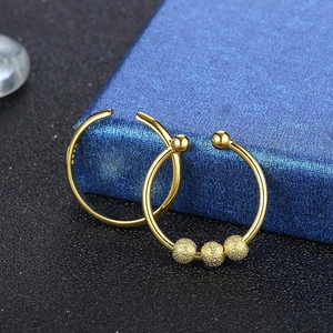 Detailed macro of gold plated S925 silver anxiety rings with rotating beads on a gift box