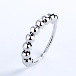Detail view of a silver minimalist anxiety ring with rotating metal beads for stress relief