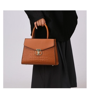 Brown faux crocodile leather handbag with elegant gold ring clasp and top handle