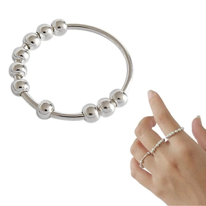 Detail of silver stress relief ring with ten movable beads shown on white background
