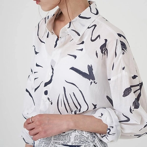 Women's white button-down shirt with black abstract print and artistic lapel design