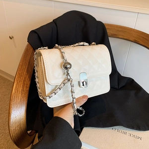 White quilted flap shoulder bag with silver chain strap and decorative metal ball