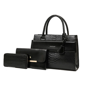 Three-piece black crocodile embossed handbag set including tote, clutch, and wallet