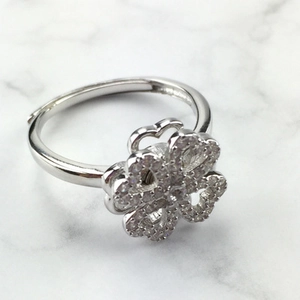 Polished silver four-leaf clover ring with crystal stones and adjustable open band