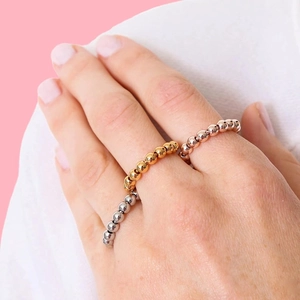 Stackable metal bead spinning rings set in silver, gold, and rose gold finish for women