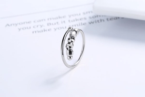 Detail of silver spinner ring featuring five faceted beads for anxiety relief