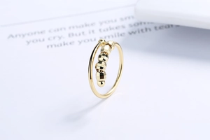 Close-up of golden fidget ring featuring five faceted beads and an adjustable open band