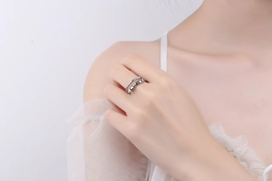 Detailed close-up of a silver fidget ring with rotating beads on a woman's finger
