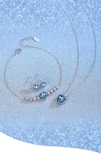 Detail of Eternal Heart jewelry set featuring blue crystal necklace, bracelet and earrings