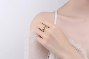 Detailed close-up of 18K gold fidget ring with movable beads for stress relief on finger