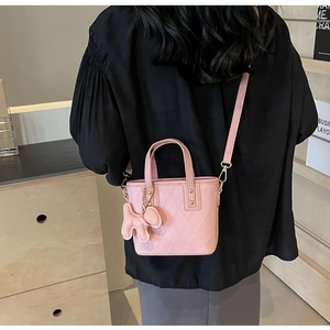 Détail du mini sac cabas rose matelassé avec charm chien mignon et ferrures dorées chic