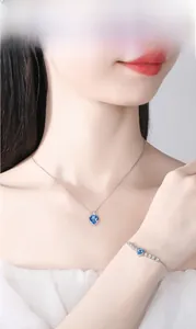 Silver-plated heart necklace and bracelet set featuring sparkling blue heart-shaped stones