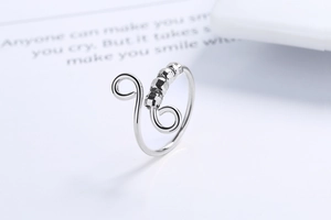 Detail of silver spinner ring with four hexagonal beads on adjustable spiral band