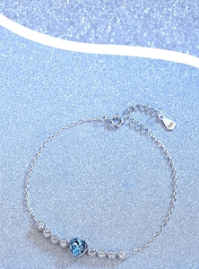 Detail of S925 silver bracelet featuring a blue heart gemstone with cubic zirconia accents
