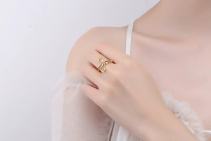Close-up of golden music note fidget ring on finger with elegant lace background