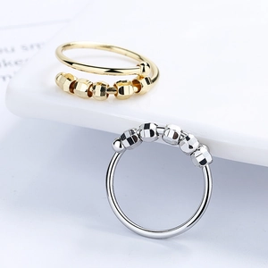 Minimalist fidget spinner rings in gold and silver with five movable faceted beads