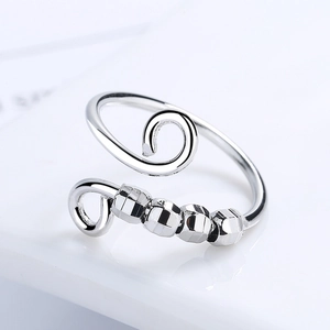 Minimalist silver spinning ring with four hexagonal beads on adjustable open band