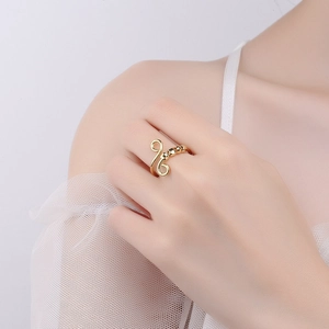 Elegant gold spiral anxiety ring with laser beads for stress relief on a model's hand