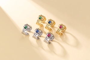 Detailed view of lava texture rings set with colorful zircon stones in gold and silver