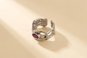 Macro detail of S925 sterling silver ring with irregular lava texture and red stone
