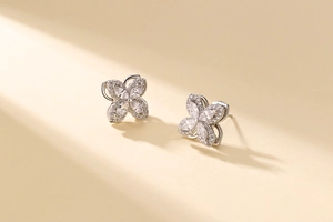 Detail of silver clover stud earrings with marquise-cut zircons and pavé setting