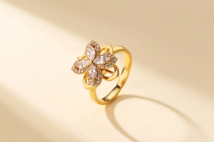 Macro detail of gold four-leaf clover ring with marquise cubic zirconia and polished band