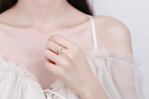 Close-up of a gold clover ring with micro-pave cubic zirconia on a female model