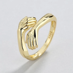 Polished gold S925 sterling silver hug ring with a minimalist hands embrace design