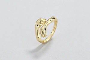 Close-up of S925 sterling silver hug ring with detailed hands and engraved hallmark