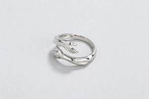 Detailed close-up of S925 sterling silver hug ring with a polished open design