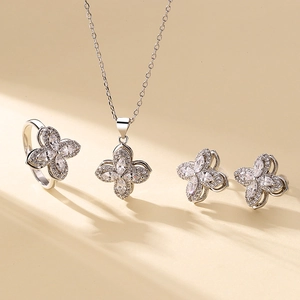 Elegant four-piece clover jewelry set with sparkling zircon necklace, ring, and earrings
