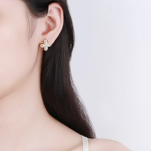 Elegant gold-plated four-leaf clover stud earrings with micro-pave white cubic zirconia