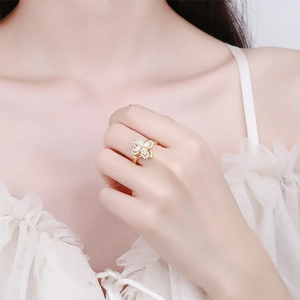 Elegant gold clover ring with zircon petals for women in a minimalist floral style