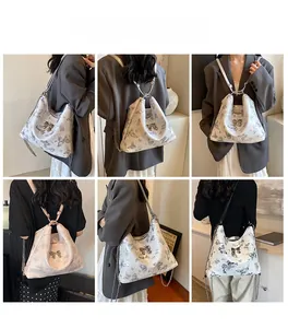 Multiple carrying styles of a butterfly print tote bag with metallic chain and bow detail