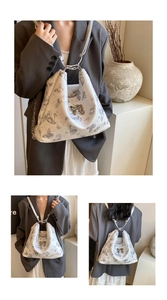 Detailed view of butterfly print tote with metallic bow clasp and chain shoulder strap