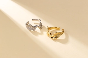 Macro detail of gold and silver liquid lava texture rings with 925 hallmark stamp