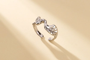 Macro side view of silver open ring with irregular lava texture and artistic organic shape