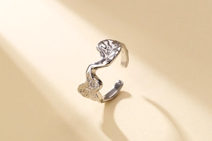 Macro detail of S925 sterling silver ring showing irregular lava texture and hallmark