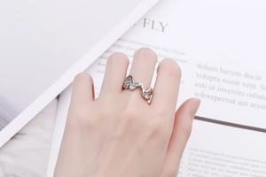 Macro detail of irregular wave-textured silver ring with a polished metallic mirror finish
