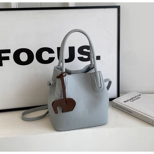 Light blue lychee texture bucket bag with a cute brown elephant charm detail