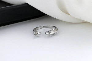 Macro shot of silver shark ring with blue zircon eye detail and open adjustable band