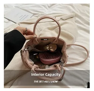 Top view of pink leather bucket bag interior showing capacity for phone and cosmetics
