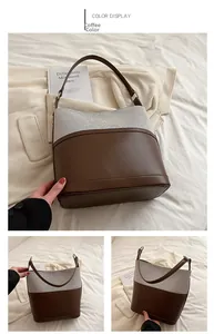 Detail view of contrast stitch bucket bag with brown leather and grey textured fabric