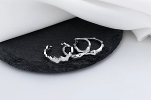 Macro detail of S925 sterling silver jewelry set featuring wavy and bamboo textures